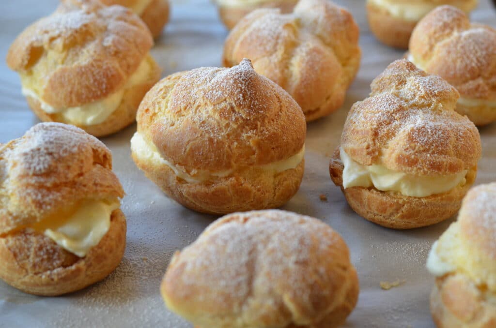 lemon cream puffs arranged on a baking sheet