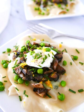 spring pea ravioli on a white plate with white napkin