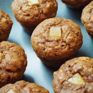 nine healthy gingerbread muffins lined up on a blue plate