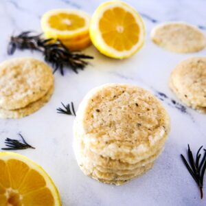rosemary lemon shortbread cookies with lemon slices in the background