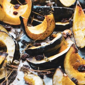 roasted acorn squash with thyme on a baking sheet