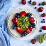vegan fruit tart with kiwi and berries on a platter