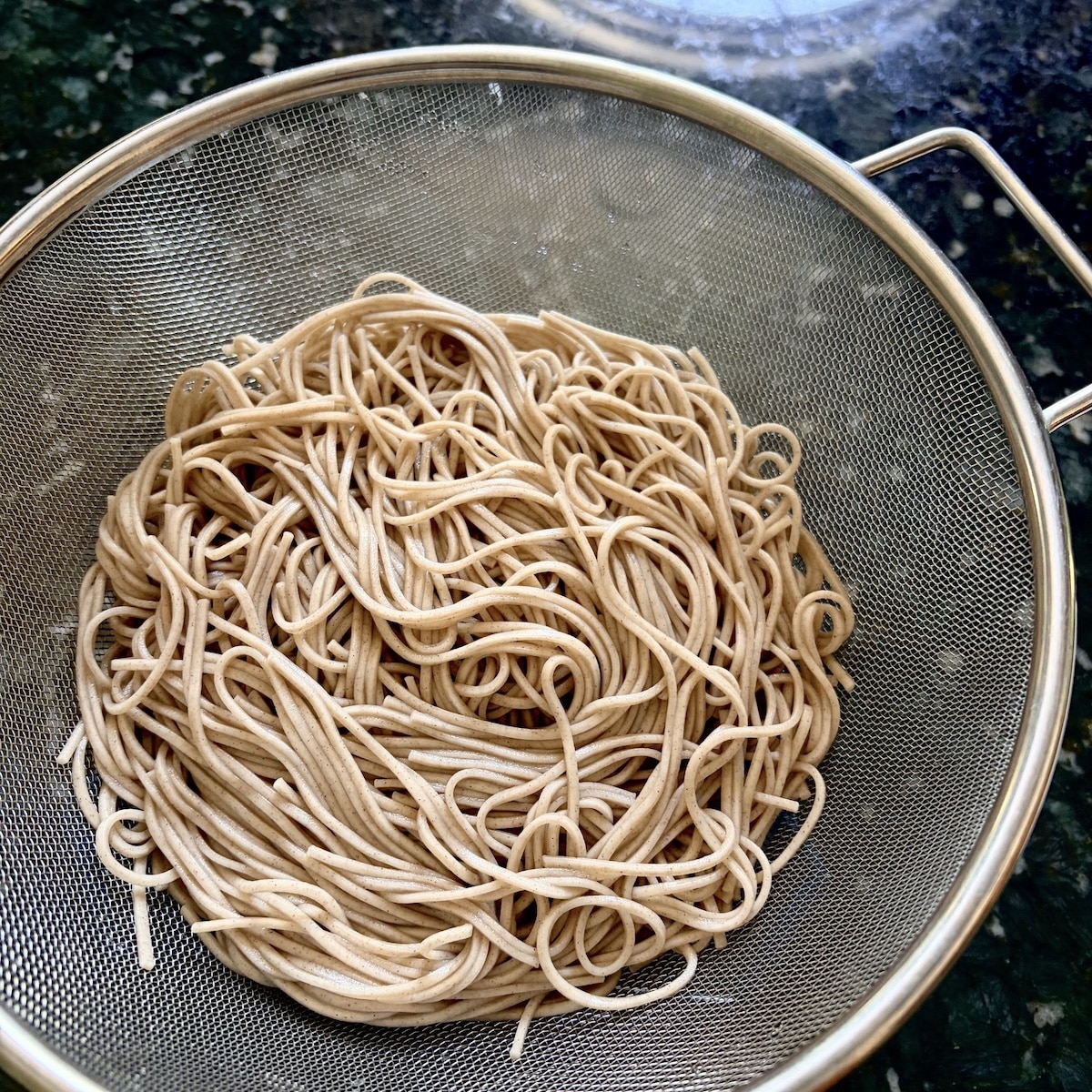 soba-noodles.jpg Cooked, drained, and rinsed soba noodles in a colander.