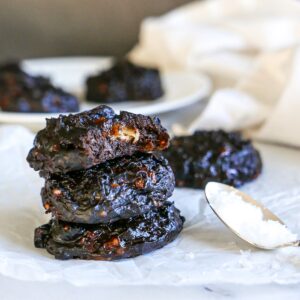 vegan peanut butter banana cookies stacked on parchment
