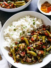 green bean and mushroom curry with white rice and two forks.