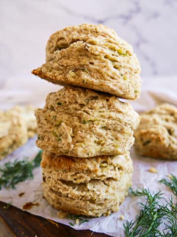 potato biscuits stacked on parchment paper.