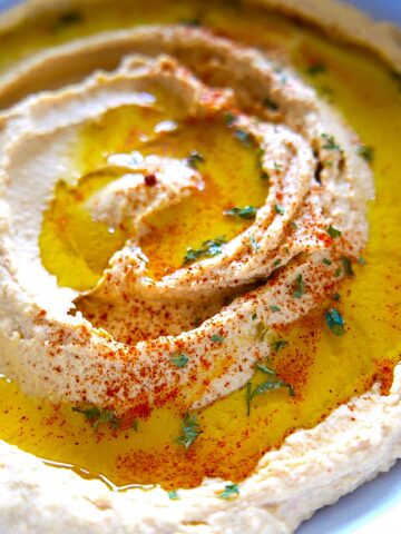paprika hummus in white bowl