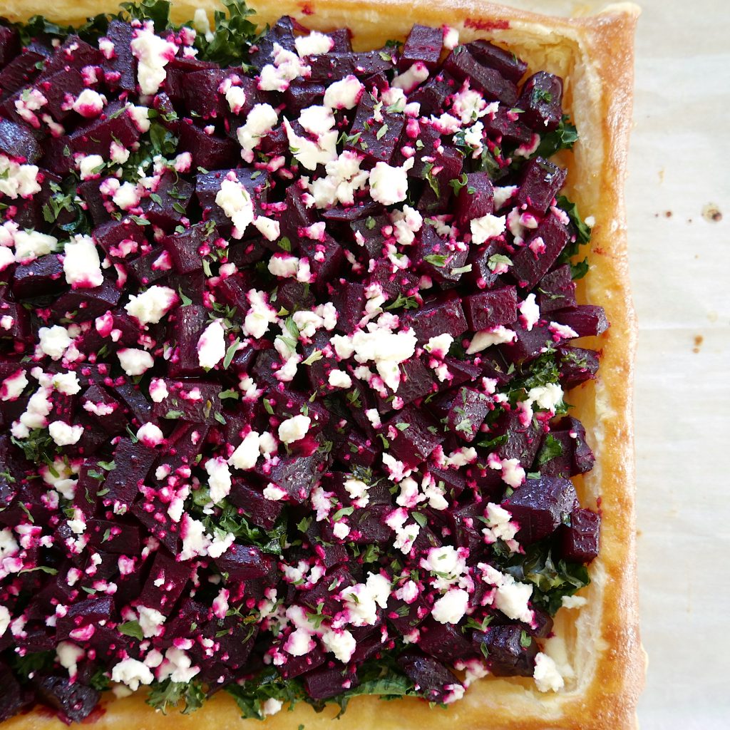 roasted beetroot tart with feta and kale on a baking sheet