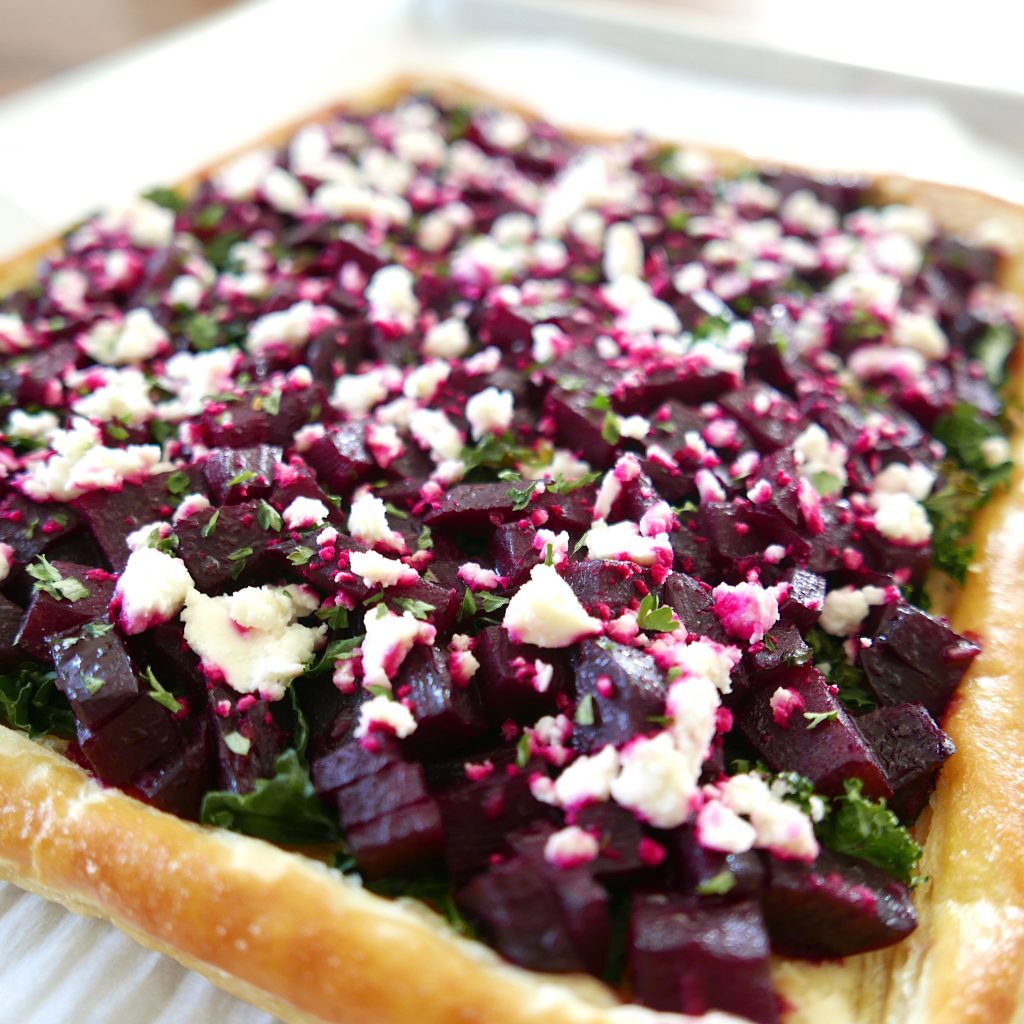 roasted beetroot tart with feta and kale on a baking sheet