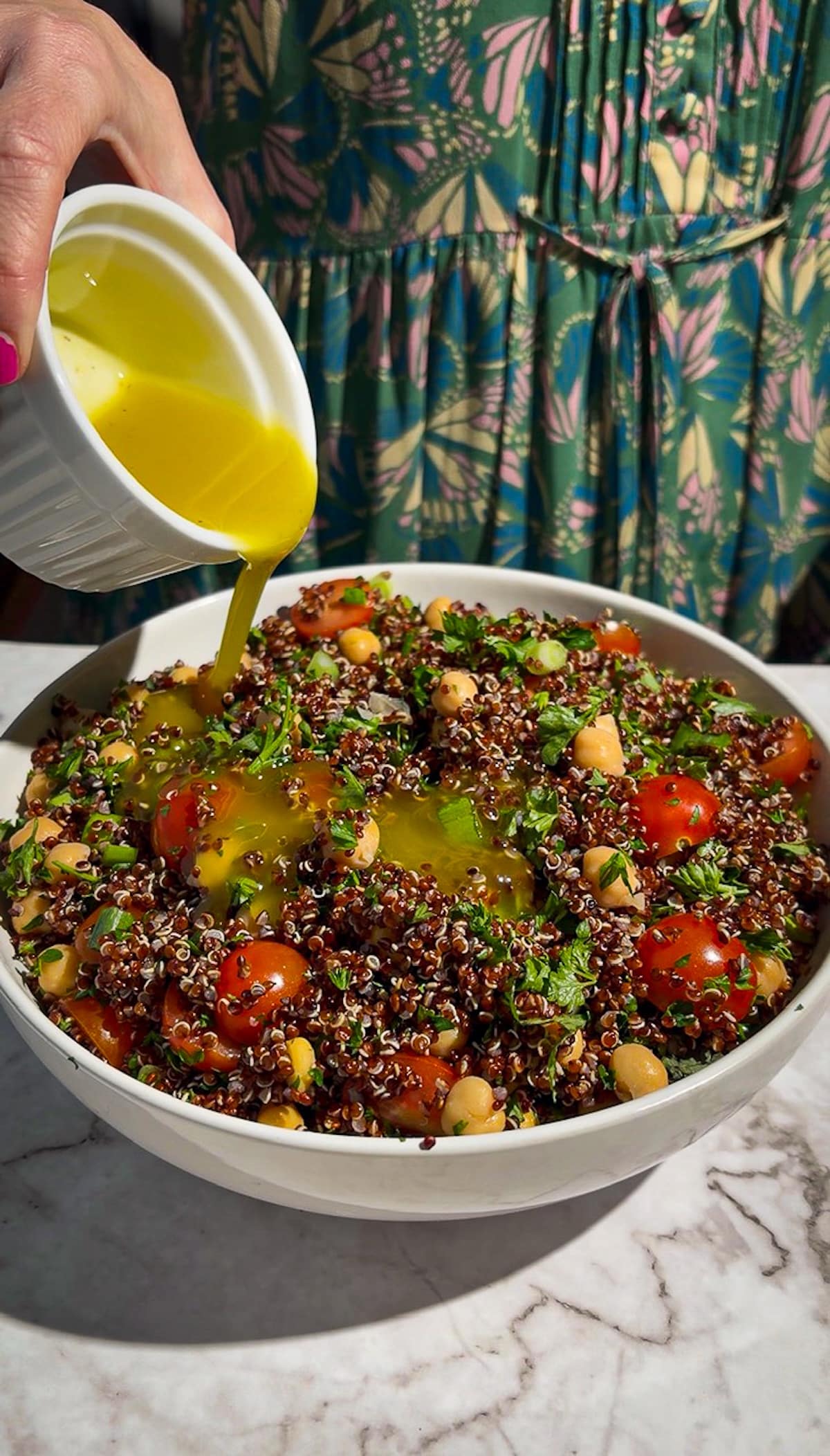 lemon-dressing-on-tabbouleh.jpg Pouring lemon dressing on top of assembled tabouli quinoa salad.