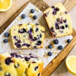 blueberry lemon pound cake sliced onto parchment paper.