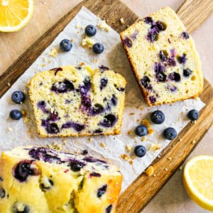 blueberry lemon pound cake sliced onto parchment paper.