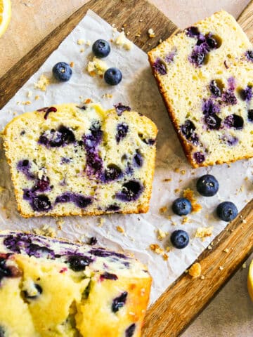 blueberry lemon pound cake sliced onto parchment paper.