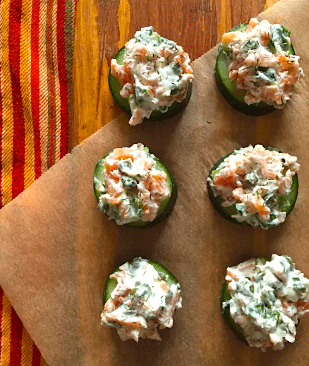 smoked salmon cucumber cups arranged on a cutting board