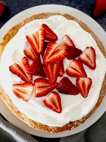 strawberry cornmeal cake on a white platter
