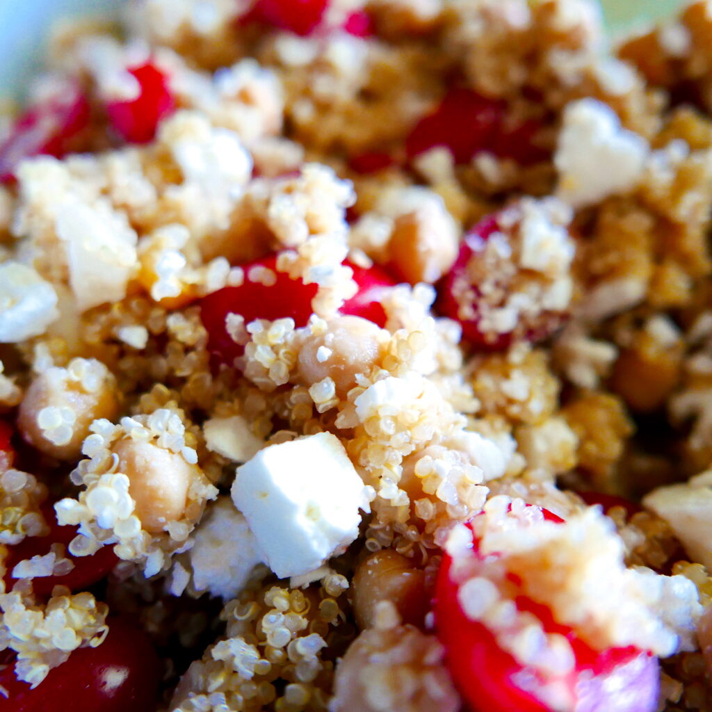 quinoa, feta, and tomatoes in a skillet