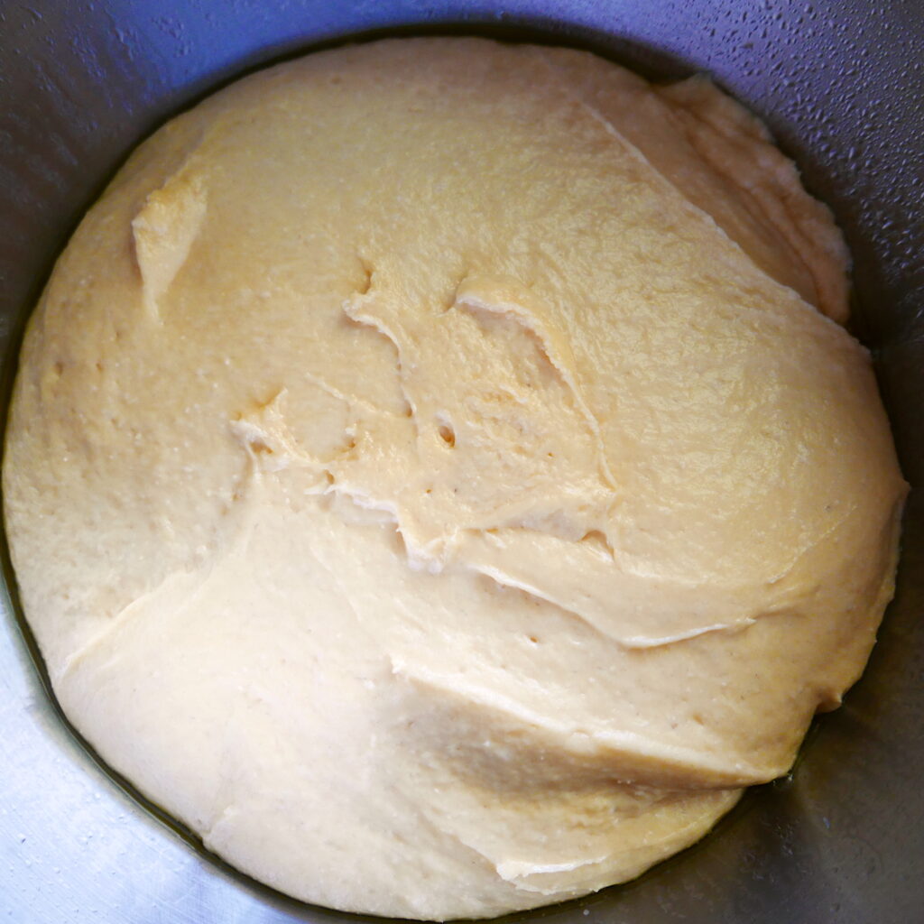 cinnamon bun dough rising in a bowl