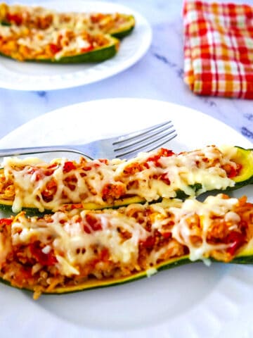 stuffed zucchini boats with rice on a plate