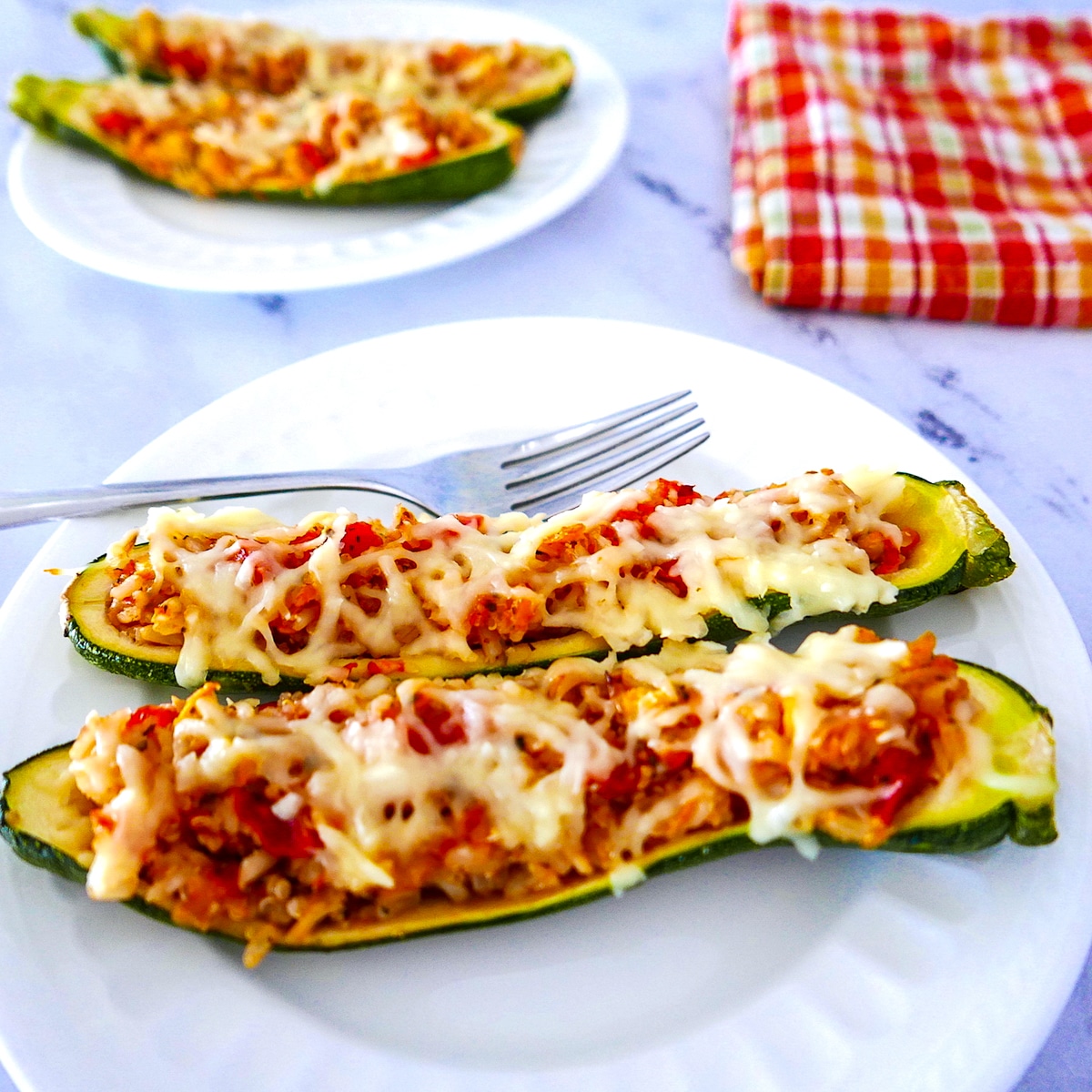 stuffed zucchini boats with rice on a plate