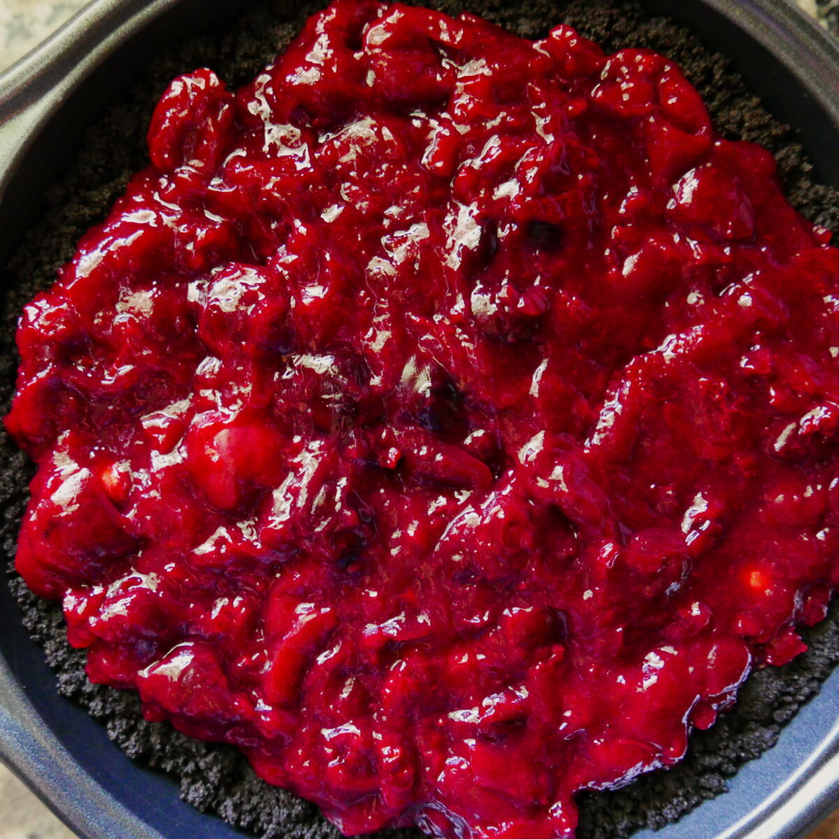 cherry filling spread on top of chocolate cookie crust.