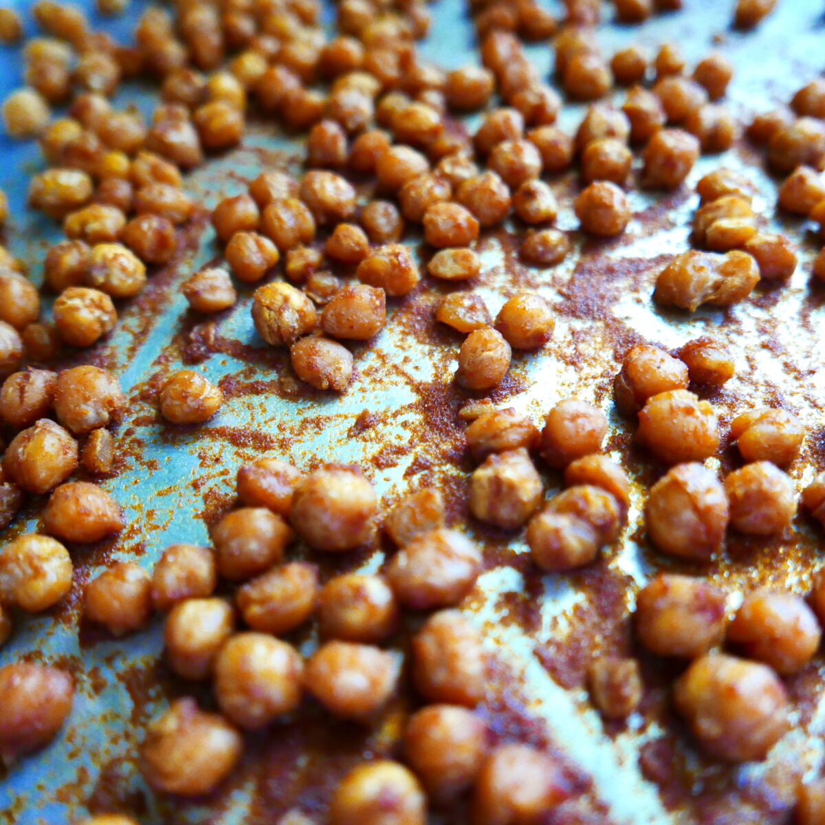 BBQ sauce added to chickpeas on a baking sheet.