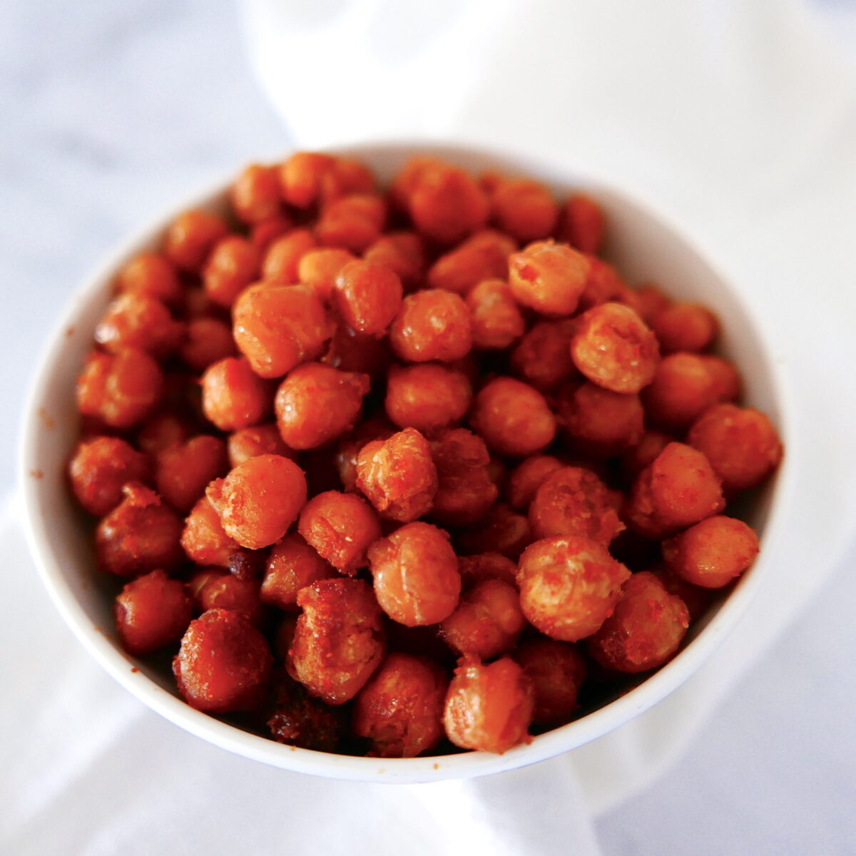 Chickpeas in a small white cup.