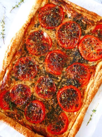 french tomato tart with puff pastry on a white countertop