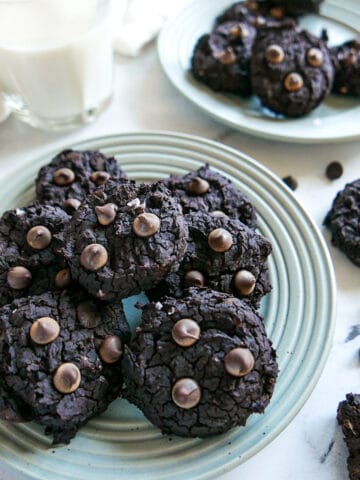 black bean cookies arranged on a gray plate.