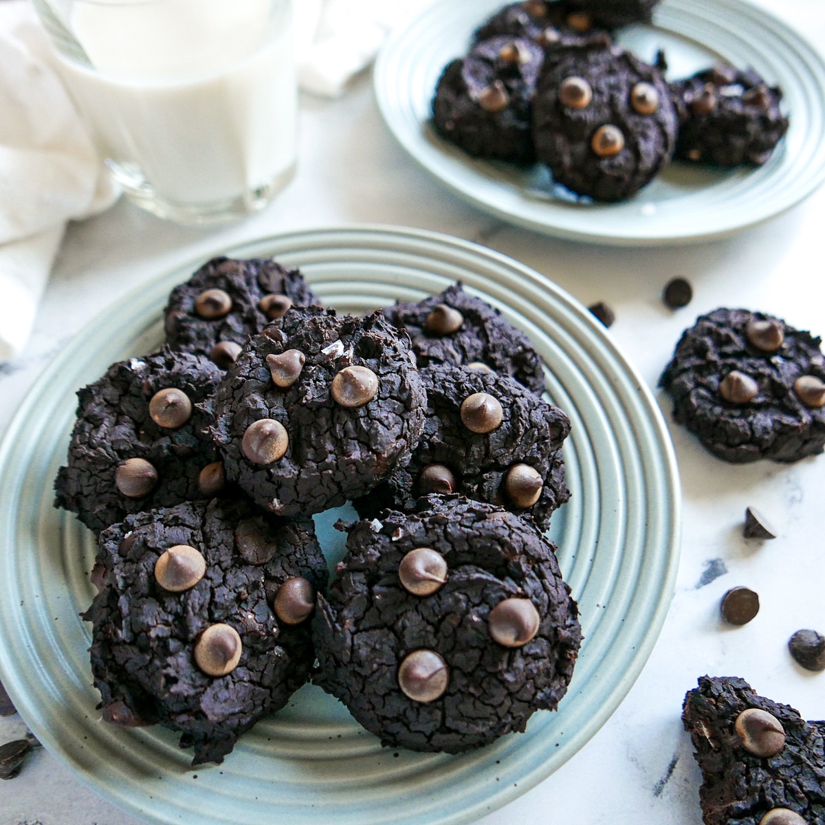 black-bean-cookies-arranged-on-a-plate.jpg black bean cookies arranged on a gray plate with more cookies in the background.