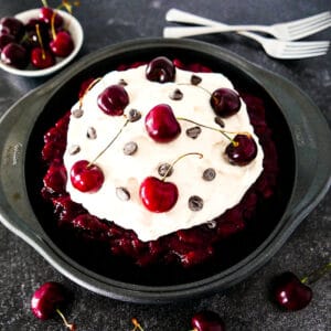 black forest pie in a pan with two forks in background.