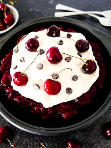 black forest pie in a pan with two forks in background.