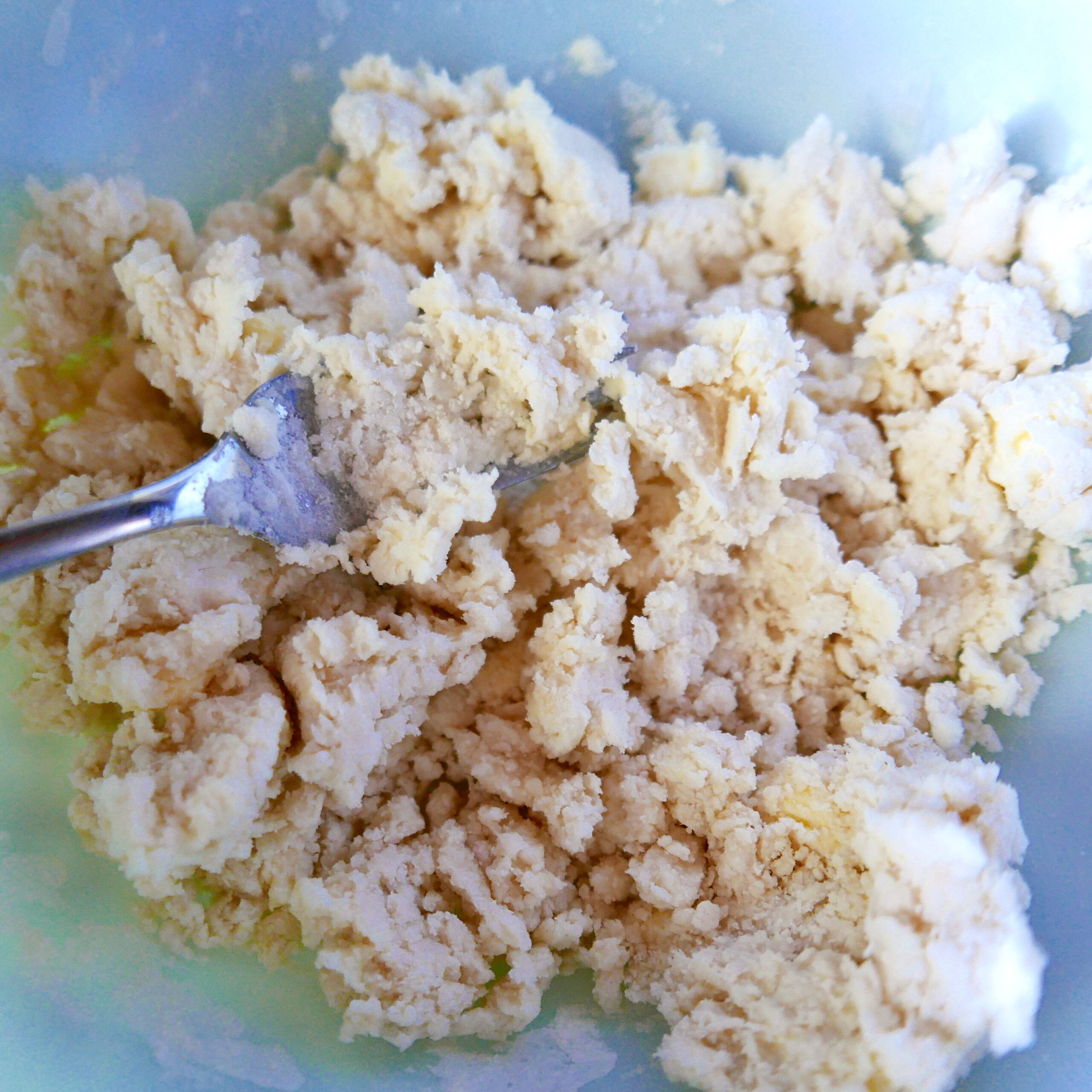 gluten free pie dough being mixed together with a fork.