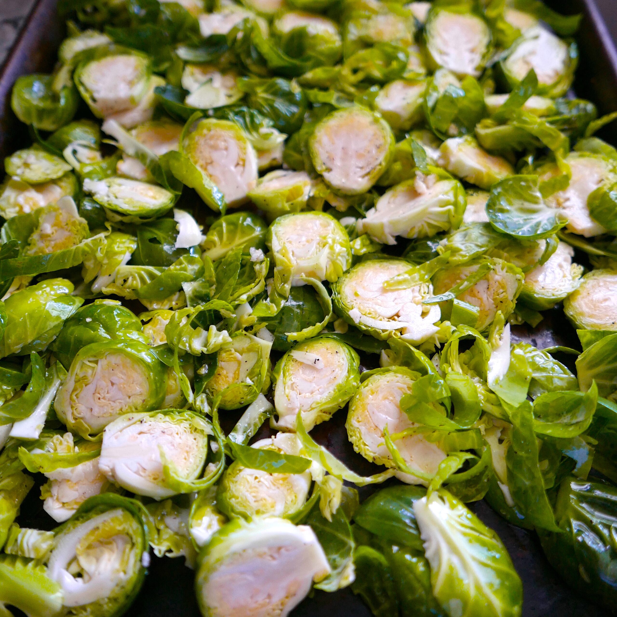 vegan brussels sprouts spread out on a baking sheet