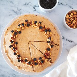 vegan peanut butter pie on a white platter with peanuts