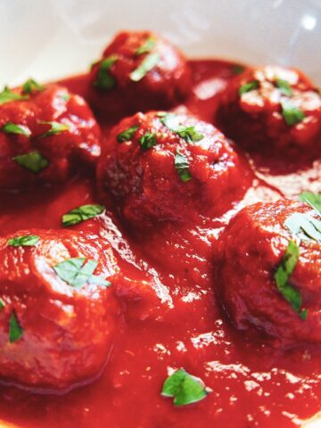 impossible burger meatballs in a white bowl garnished with parsley