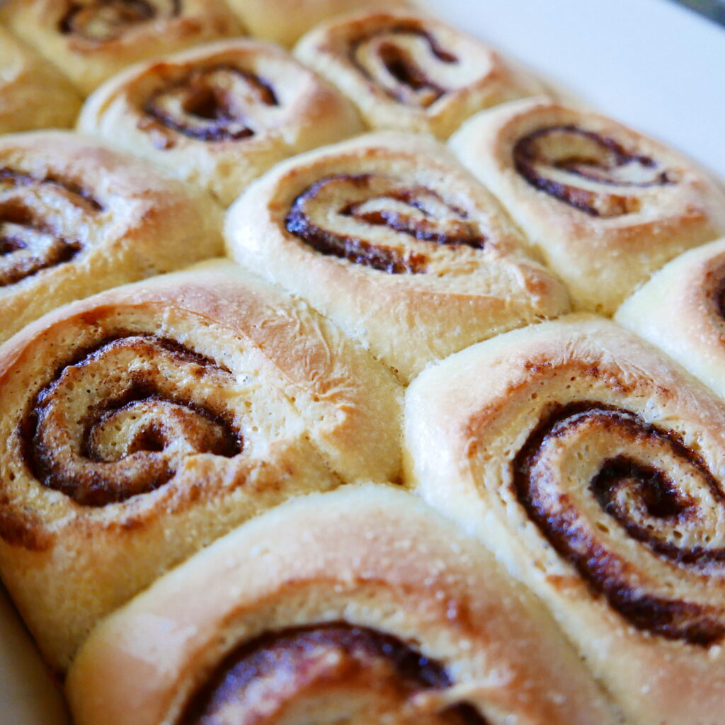 unfrosted cinnamon rolls in a baking dish