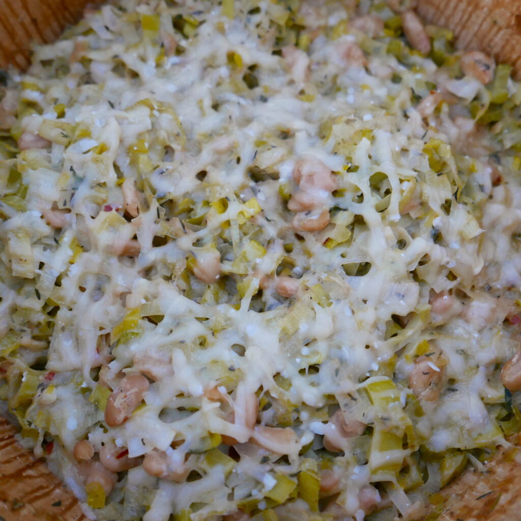 leeks, white beans, and parmesan being cooked in a large pot