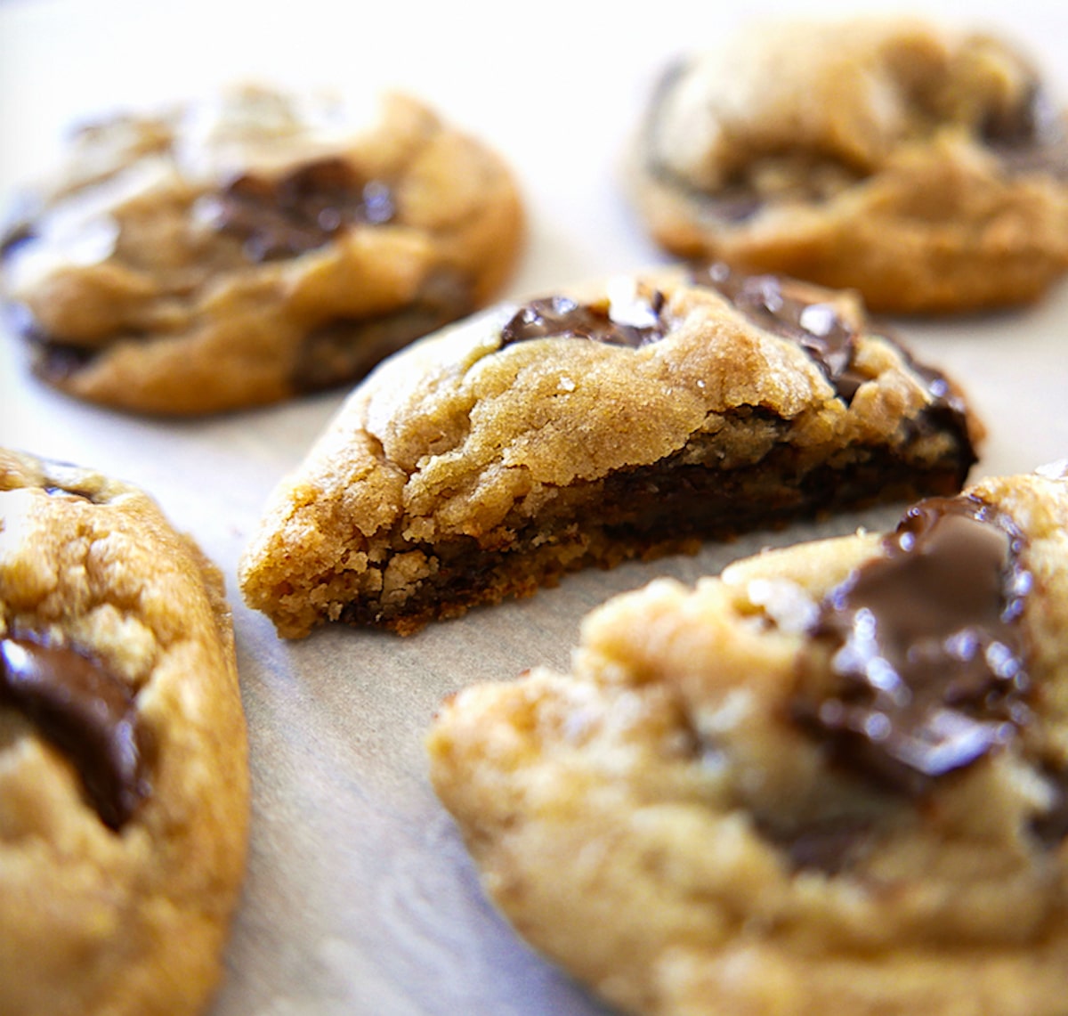 close up of inside of brown butter chocolate chip cookie on parchment paper