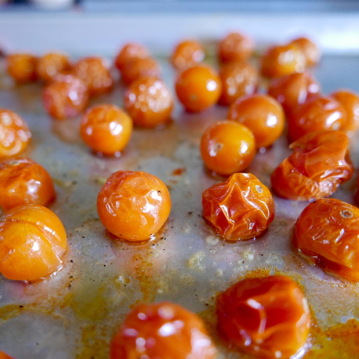 roasted tomatoes on a baking sheet.