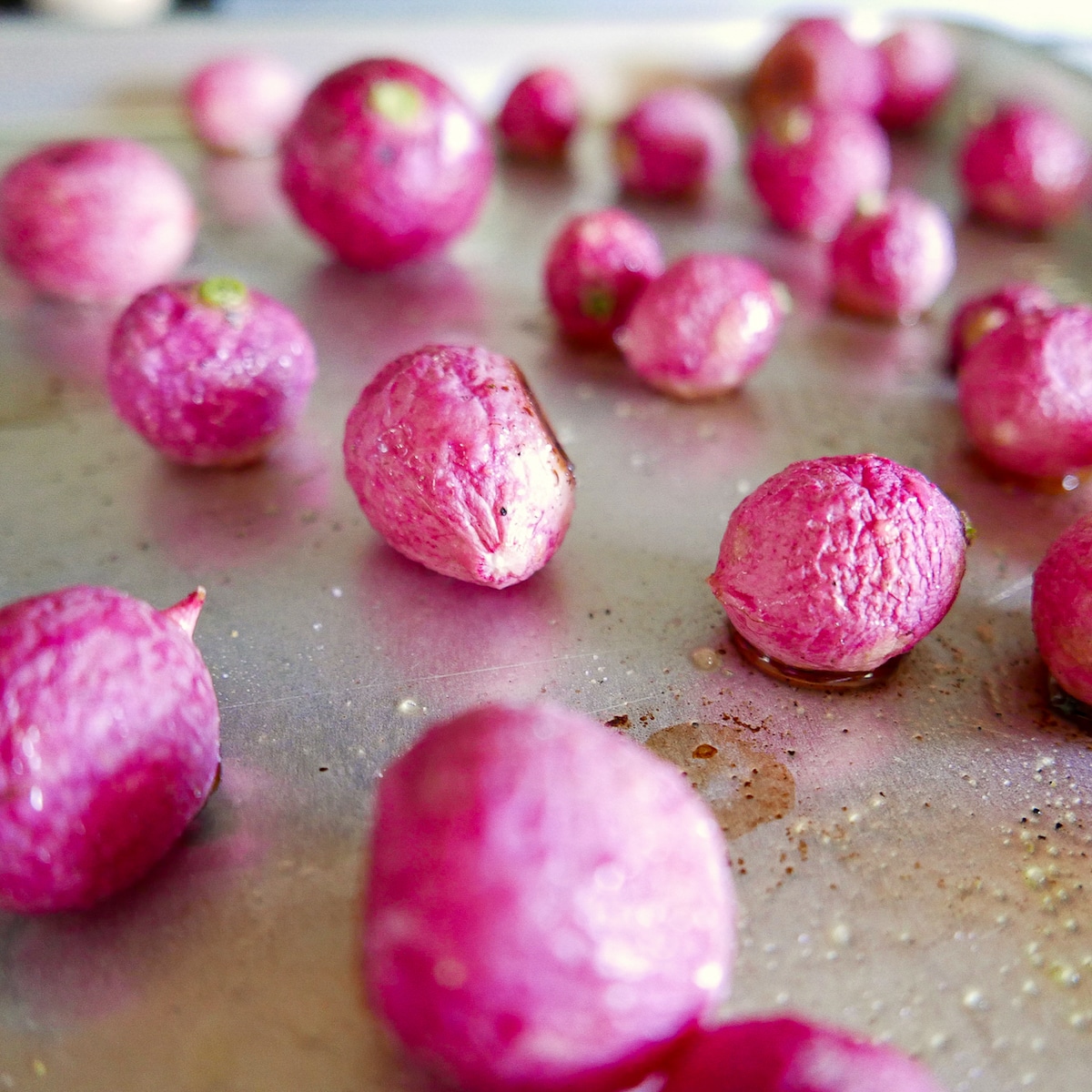 roasted radishes arranged on a baking sheet.