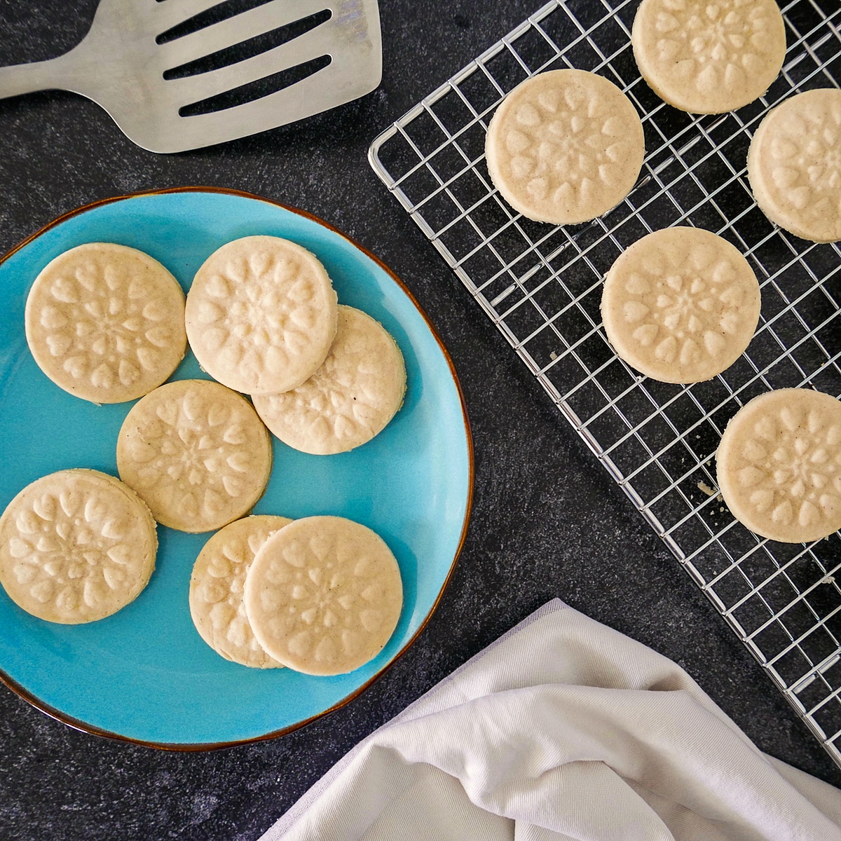shortbread cookies on a cooling rack and arranged on a blue plate.