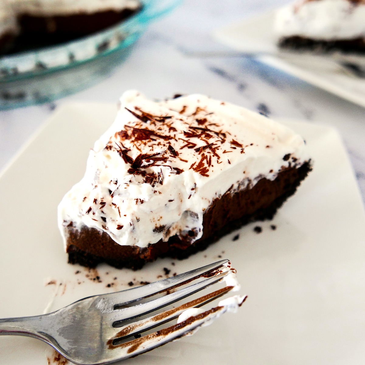 chocolate-cream-pie.jpg slice of chocolate cream pie on a white plate with fork