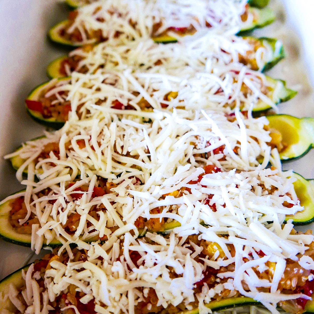 mozzarella topped zucchini on a baking sheet