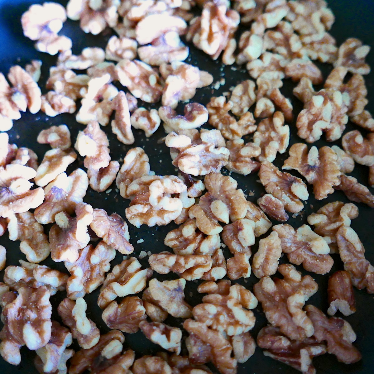 toasted walnuts in a skillet