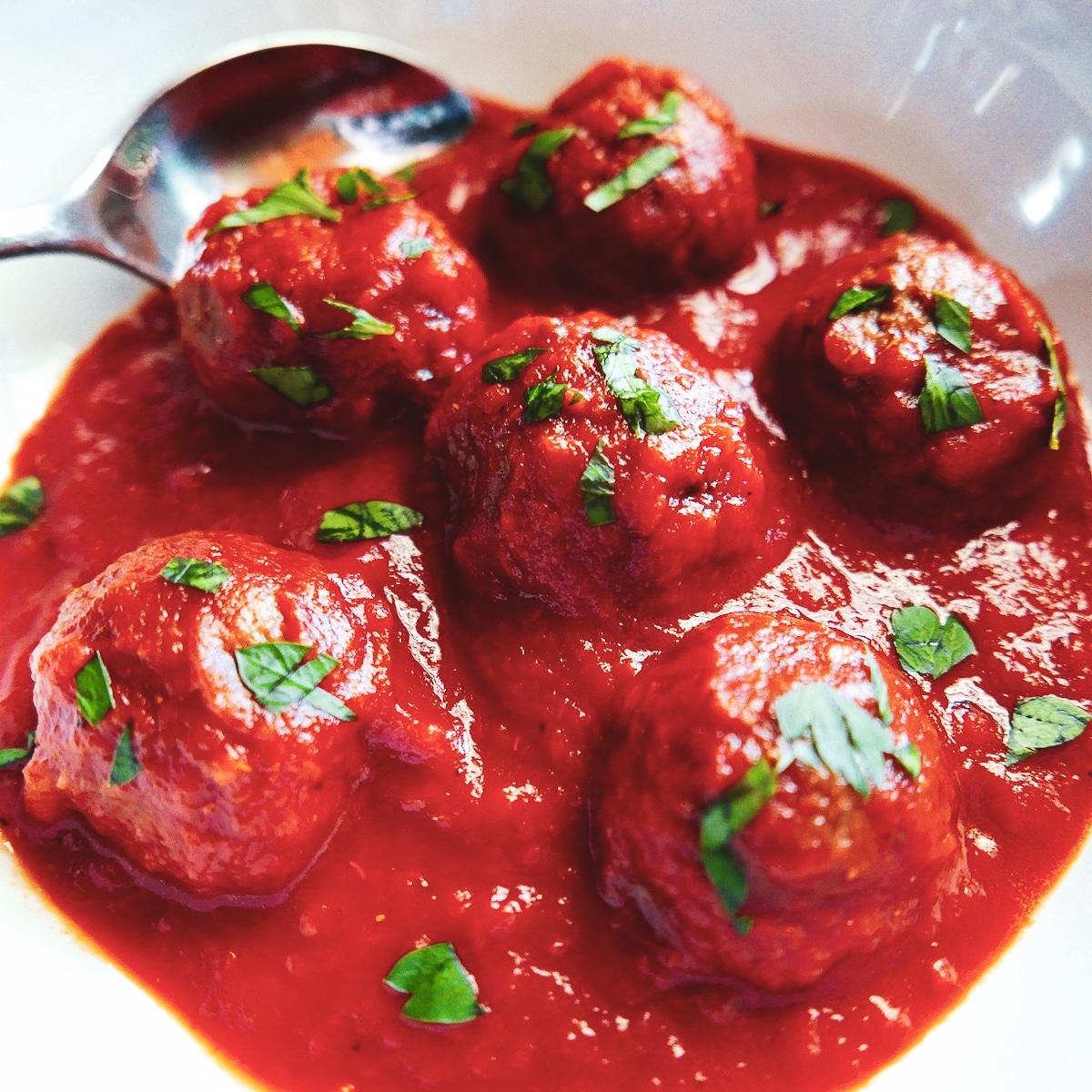 six impossible meatballs in bowl with spoon.