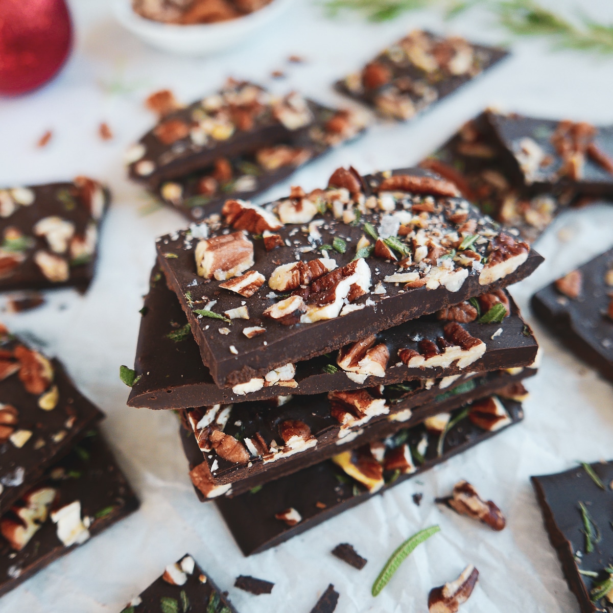 chocolate-pecan-bark.jpg pecan rosemary chocolate bark stacked with more in background