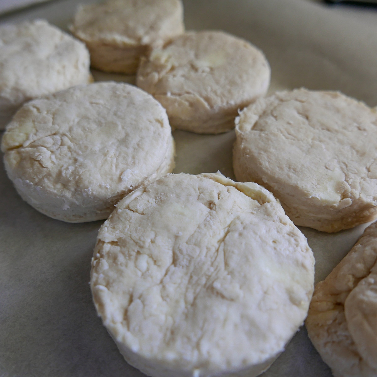 biscuits placed snugly on a baking pan.