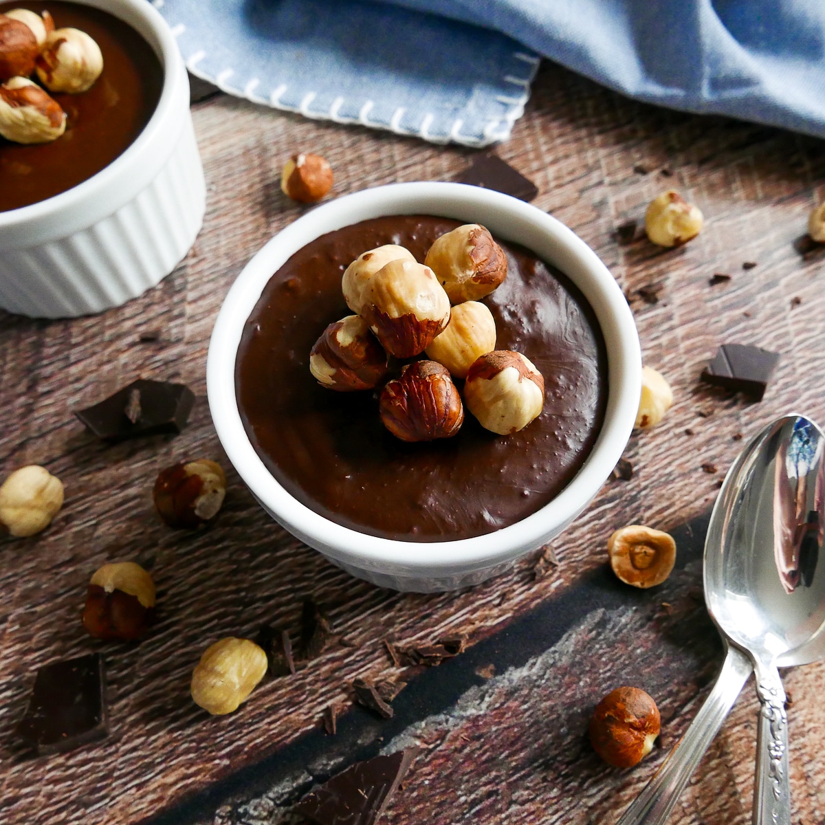 nutella with hazelnuts in cup with spoon