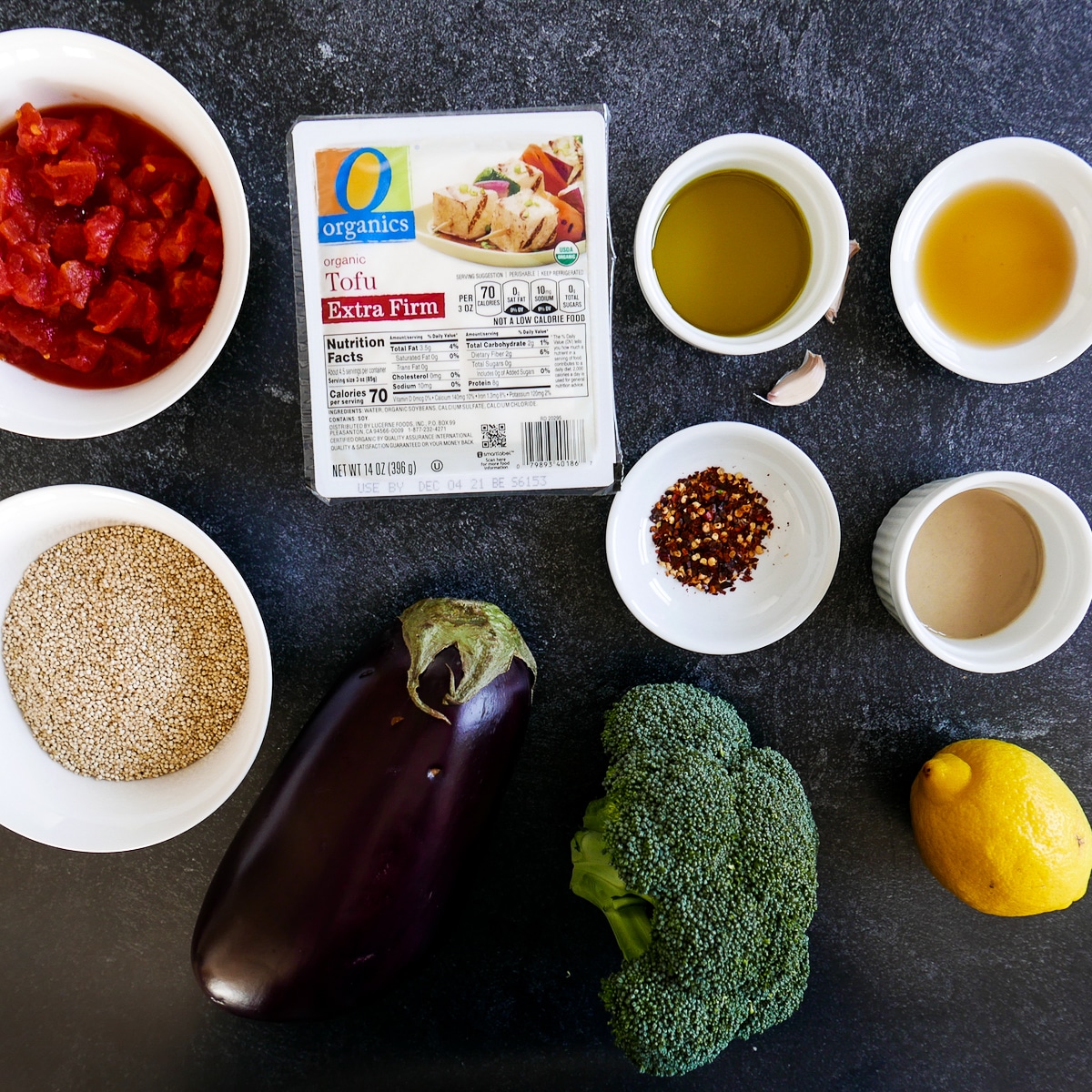 tomatoes, broccoli, eggplant, tofu, quinoa, tahini, and other recipe ingredients.