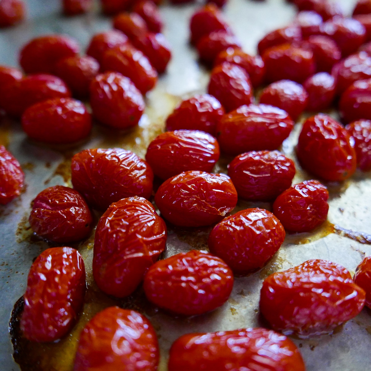 roasted cherry tomatoes on a baking sheet.